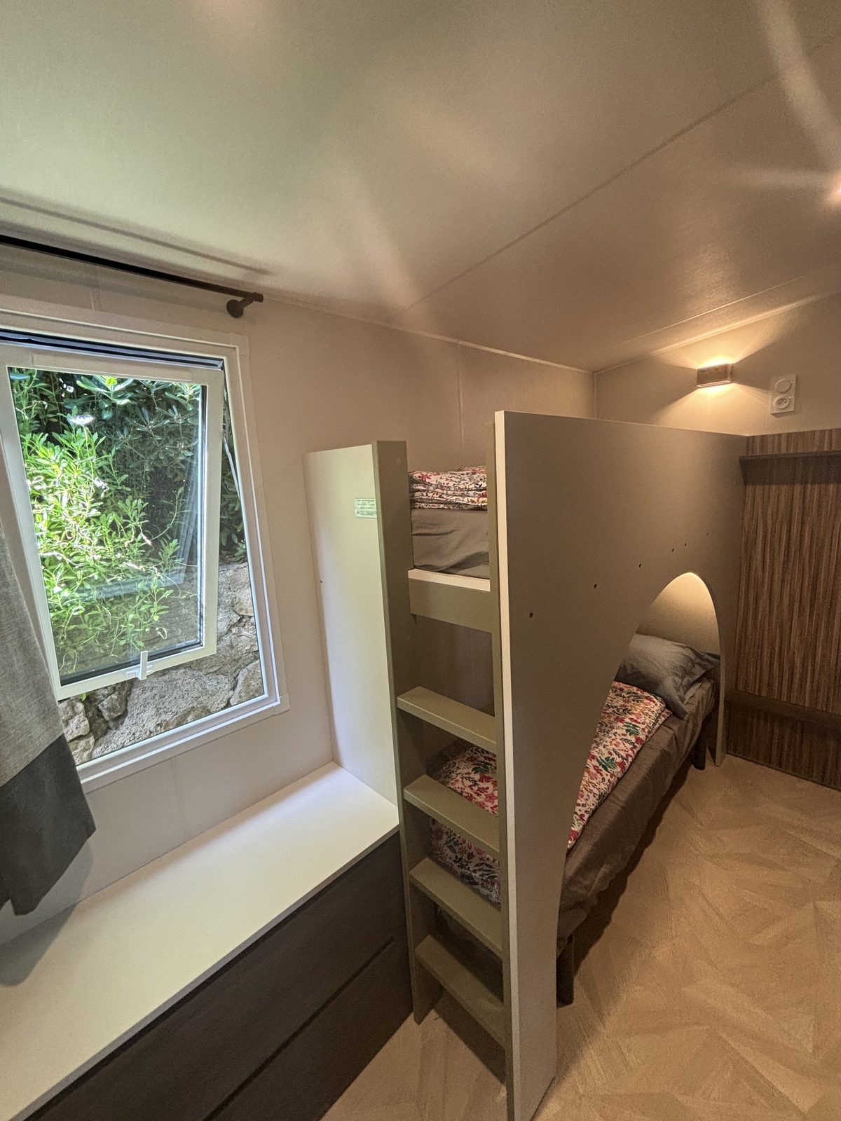 Children's room with bunk beds and a garden window